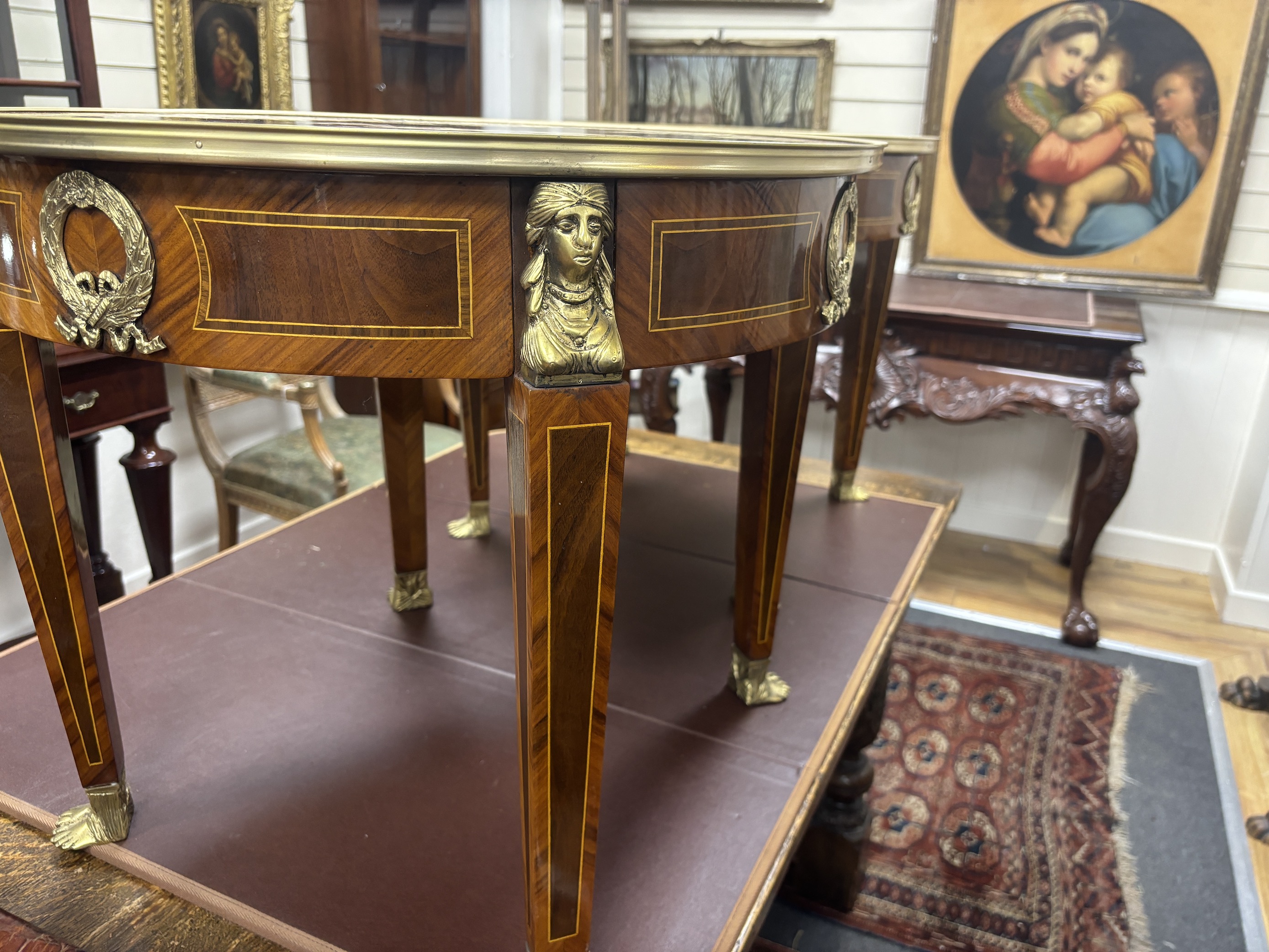 A pair of Empire style circular gilt metal mounted occasional tables, diameter 61cm, height 53cm
